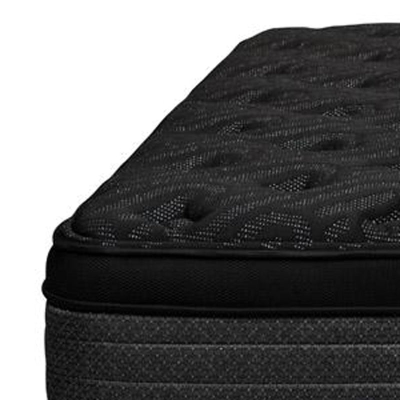 Close-up corner of dark euro top hybrid mattress with black stitched edge