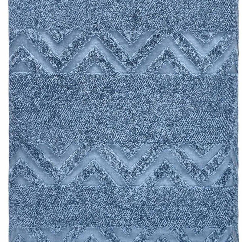 Blue bath sheet close-up showing raised chevron jacquard texture across the surface