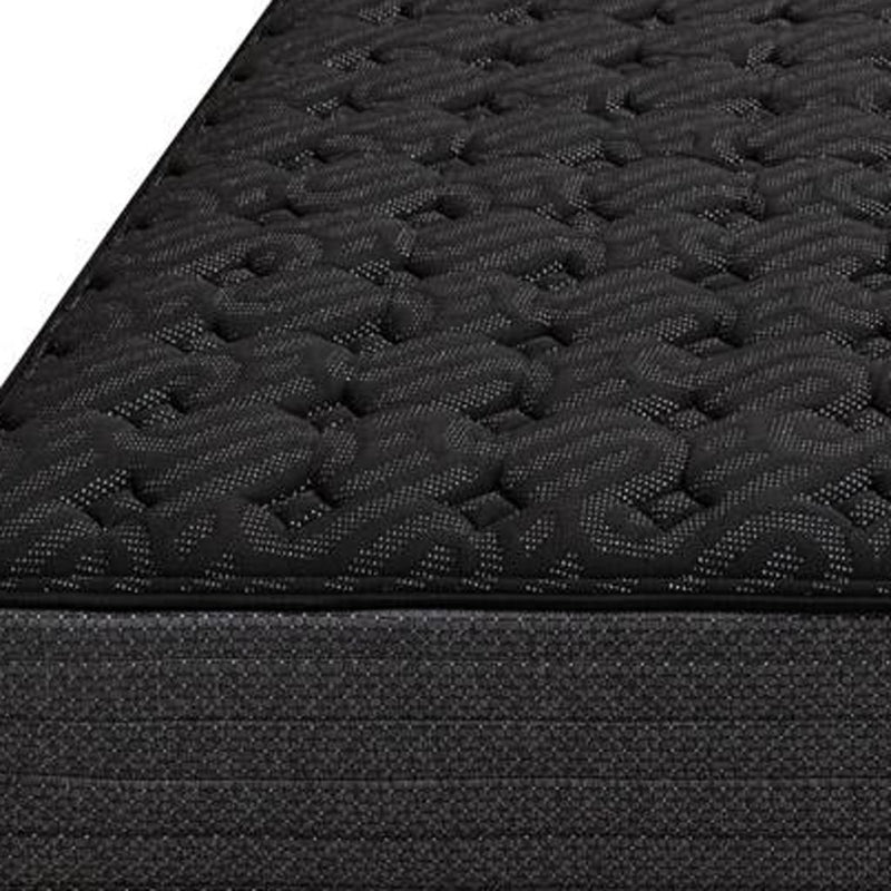 Dark quilted mattress surface with raised foam-and-gel pattern texture