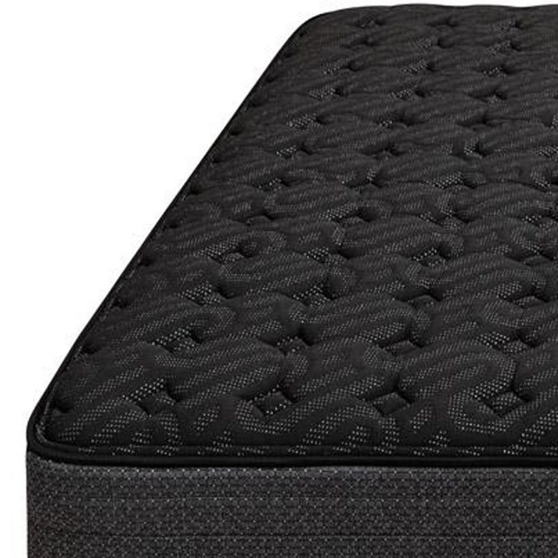Black mattress corner showing quilted top texture and stitched edge
