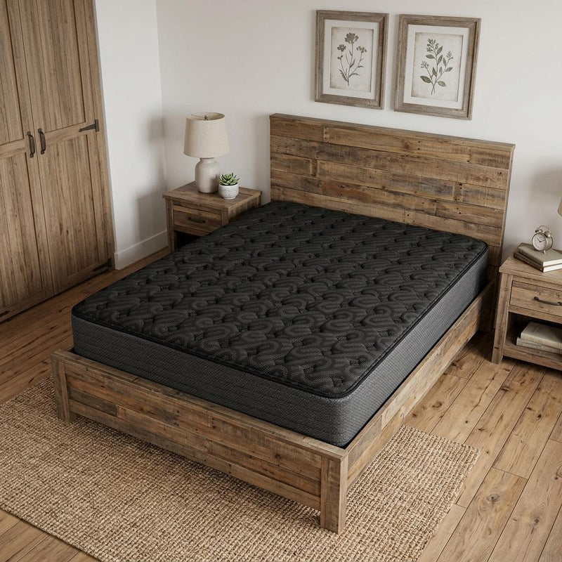 Black firm hybrid mattress on a platform bed with quilted top
