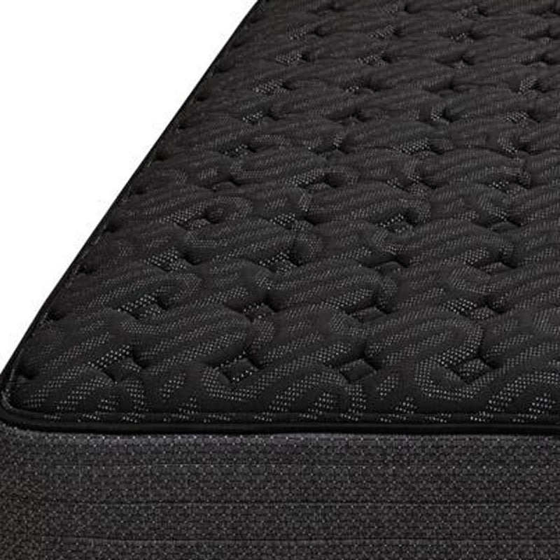 Close-up of black quilted mattress surface and fabric edge stitching