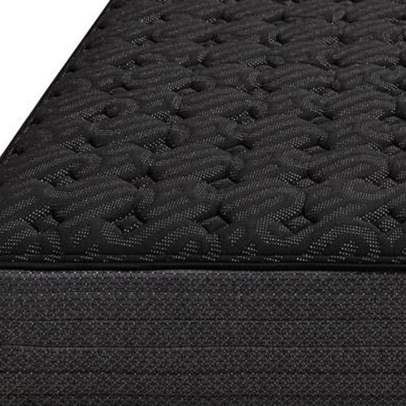 Black quilted mattress top with tufted foam pattern and dark fabric border