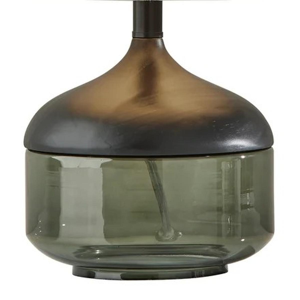 Smoky green glass table lamp with a bronze gradient base and black metal accents, perfect for modern decor.