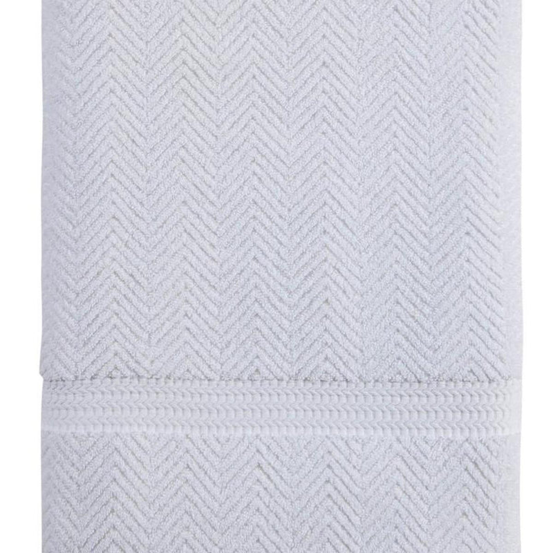 White chevron bath sheet with textured knit weave and horizontal border.