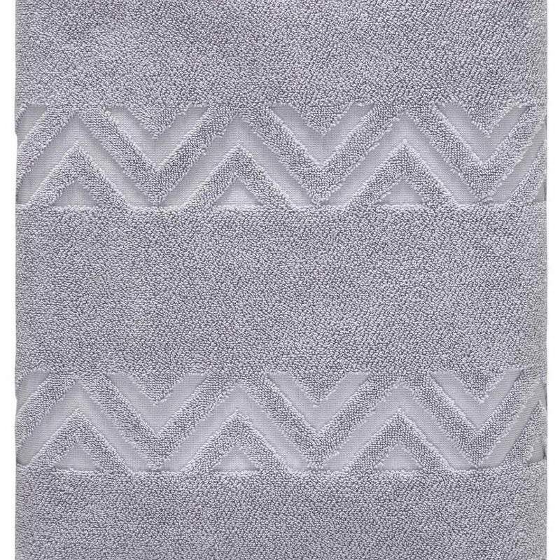 Light gray bath towel with textured jacquard chevron zigzags, close-up