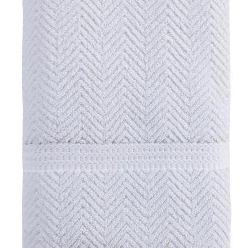White chevron bath towel showing folded hem and textured weave pattern