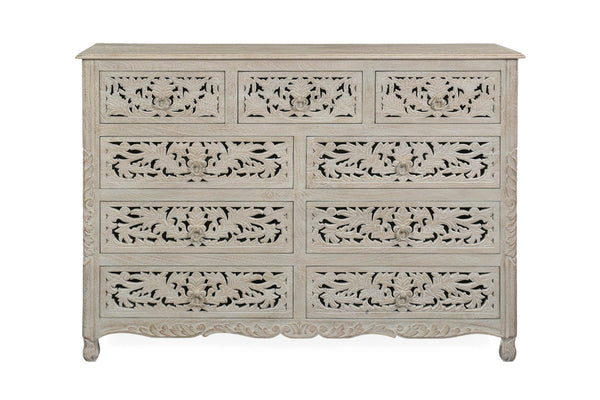 Whitewashed solid wood nine-drawer dresser with ornate carved floral drawer fronts