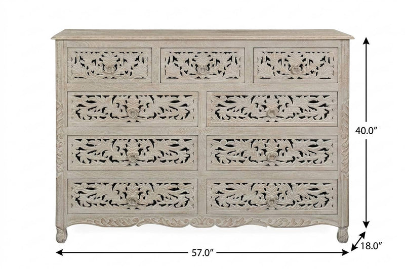 Whitewashed solid wood nine-drawer dresser with carved floral drawer fronts and tapered legs