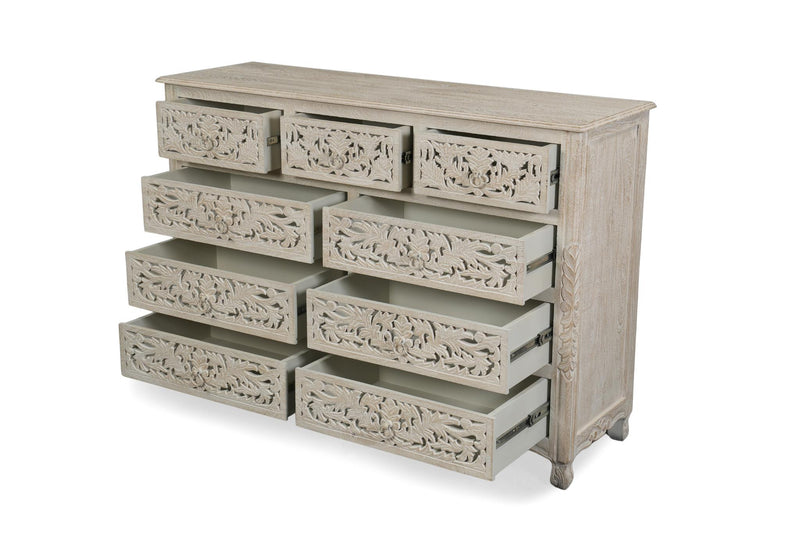 Whitewashed solid wood nine-drawer dresser with carved floral drawer fronts, open drawers
