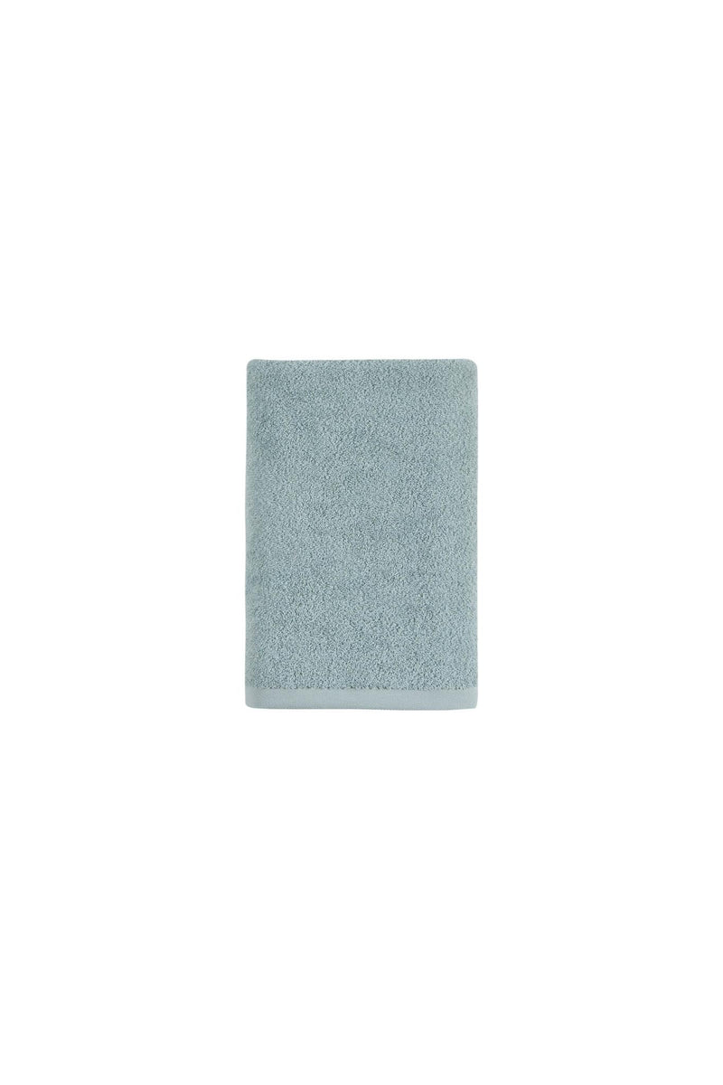 Light blue cotton bath towel, neatly folded square