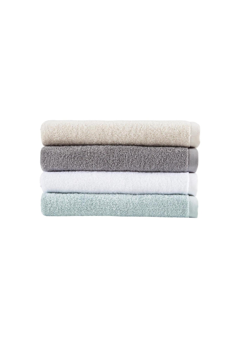 Stack of cotton bath towels in white, gray, and light blue