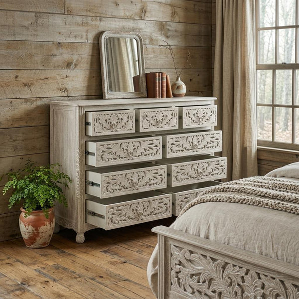 Gray carved wood nine-drawer dresser with ornate floral drawer fronts and recessed drawers