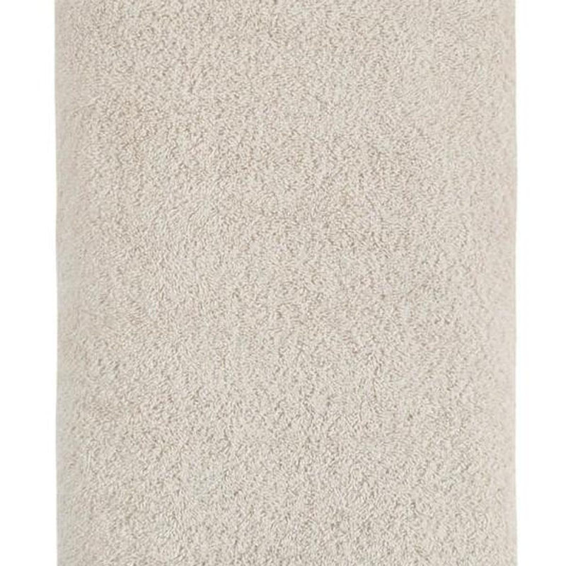 Beige Turkish cotton bath towel fabric close-up, textured loop pile surface