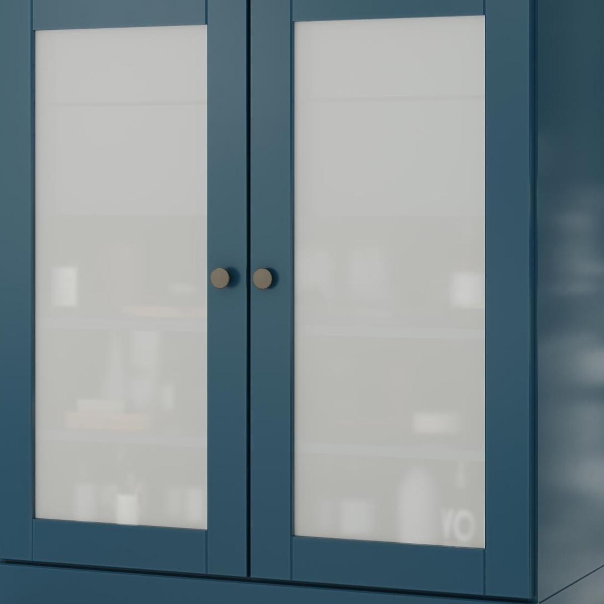 Teal blue linen cabinet with two glass doors and central vertical divider, round knobs