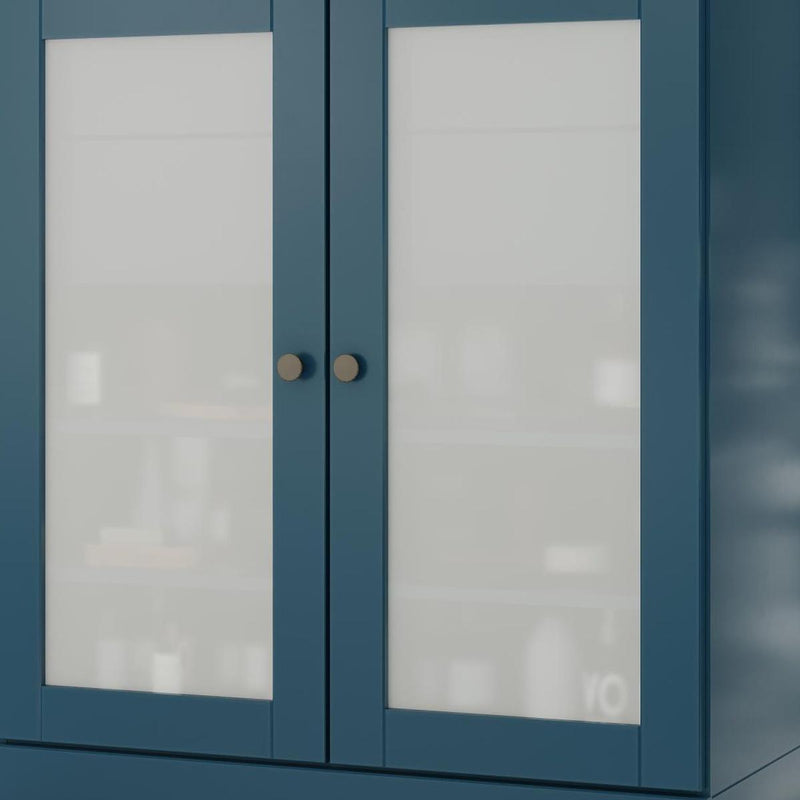 Teal blue linen cabinet with two glass front doors, central divider, and round knobs
