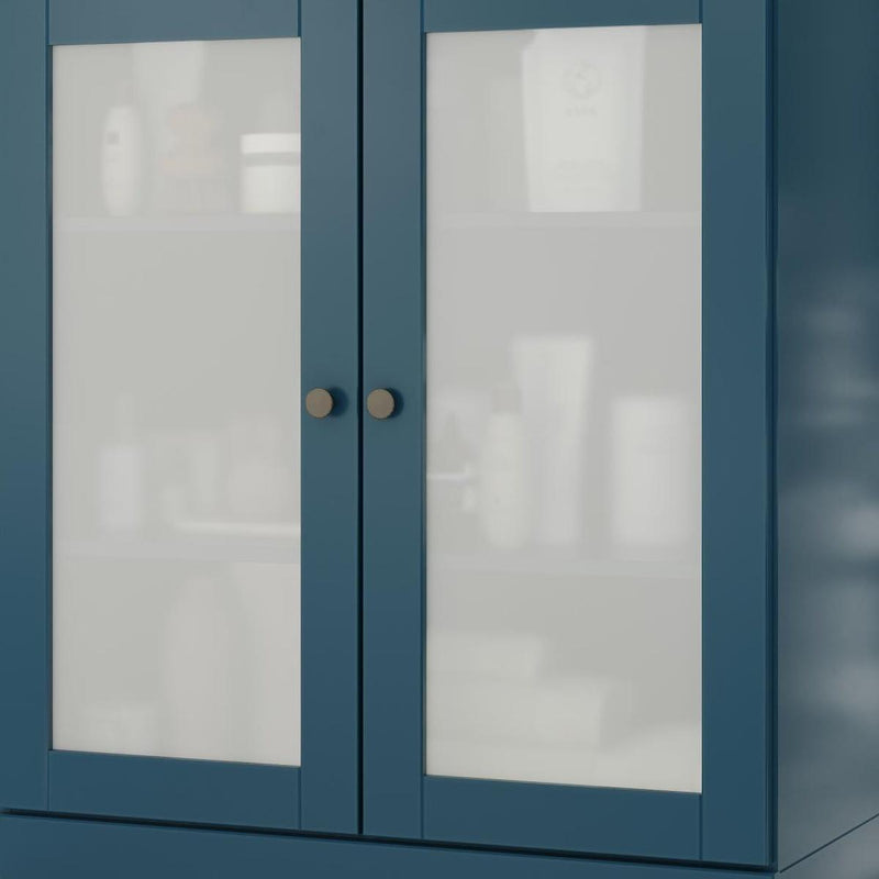 Teal blue cabinet doors with clear glass panels and two round brass-tone knobs