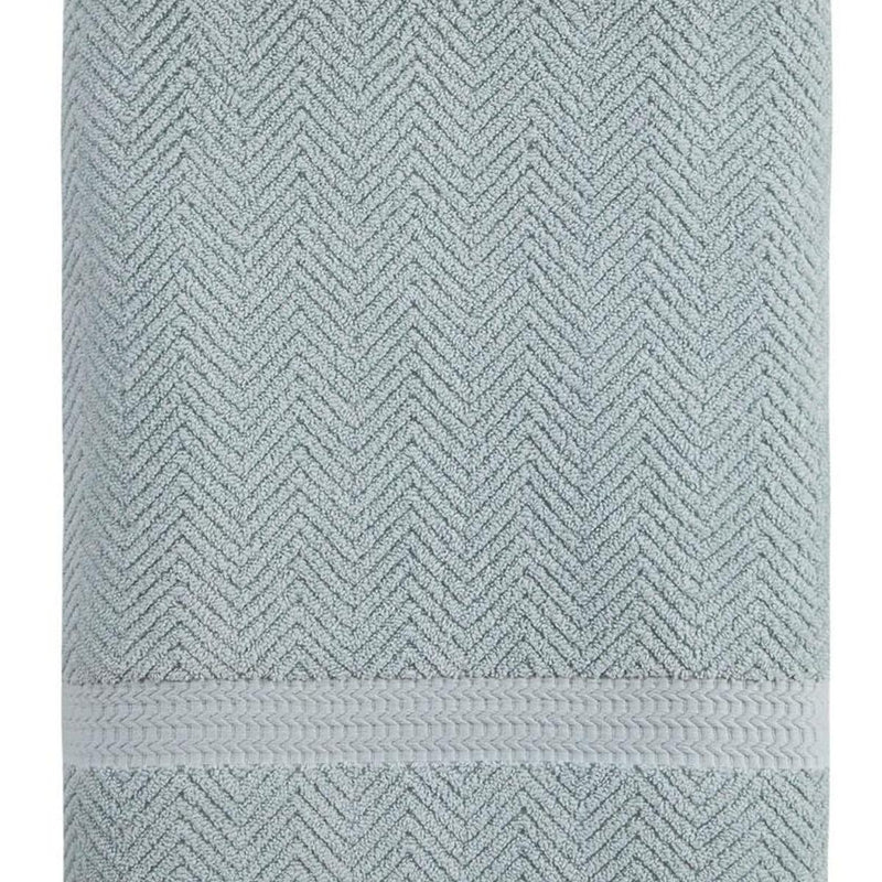 Light blue Turkish cotton bath towel with raised chevron texture and stitched hem