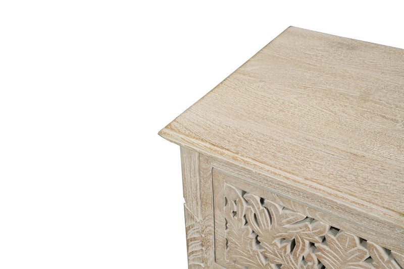 Close-up of distressed white nightstand top edge with carved drawer front detail