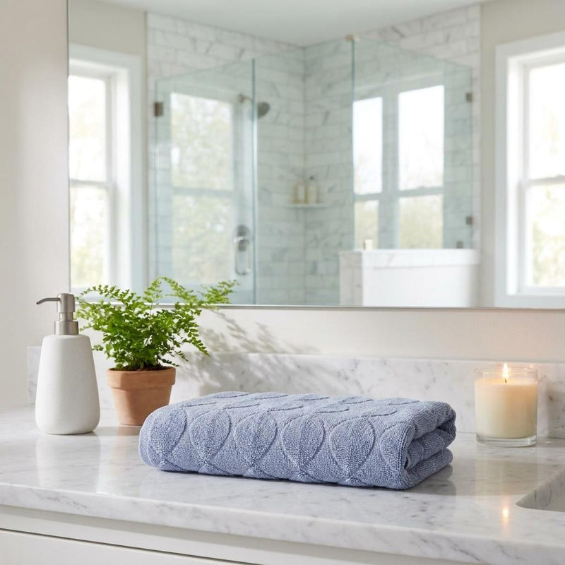 Blue bath towel folded, jacquard scalloped loop texture