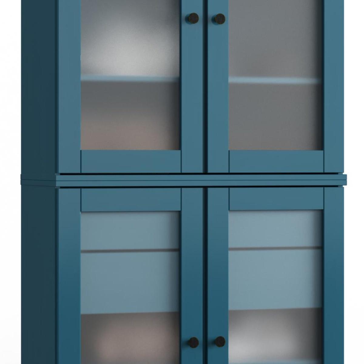 Teal blue wood cabinet door with glass panels, black knobs, and interior shelves