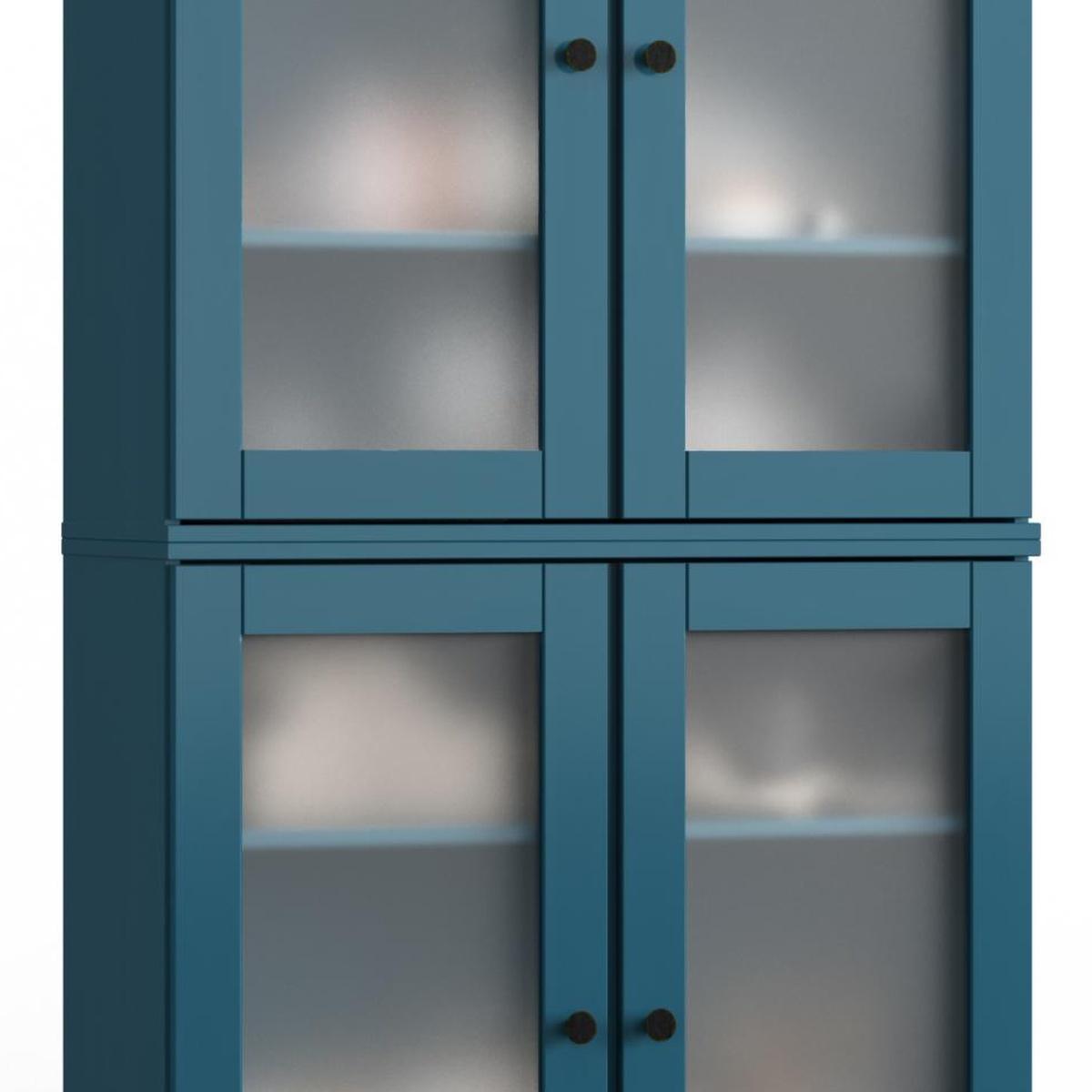 Teal wood cabinet doors with glass panels and dark round knobs