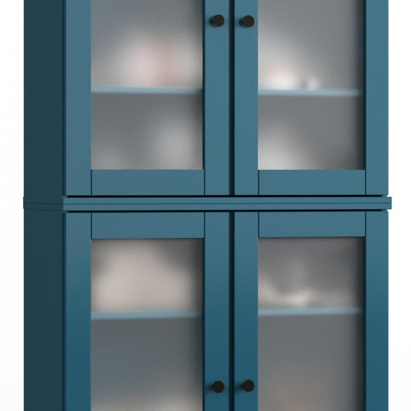 Teal wood cabinet doors with glass panels and dark round knobs
