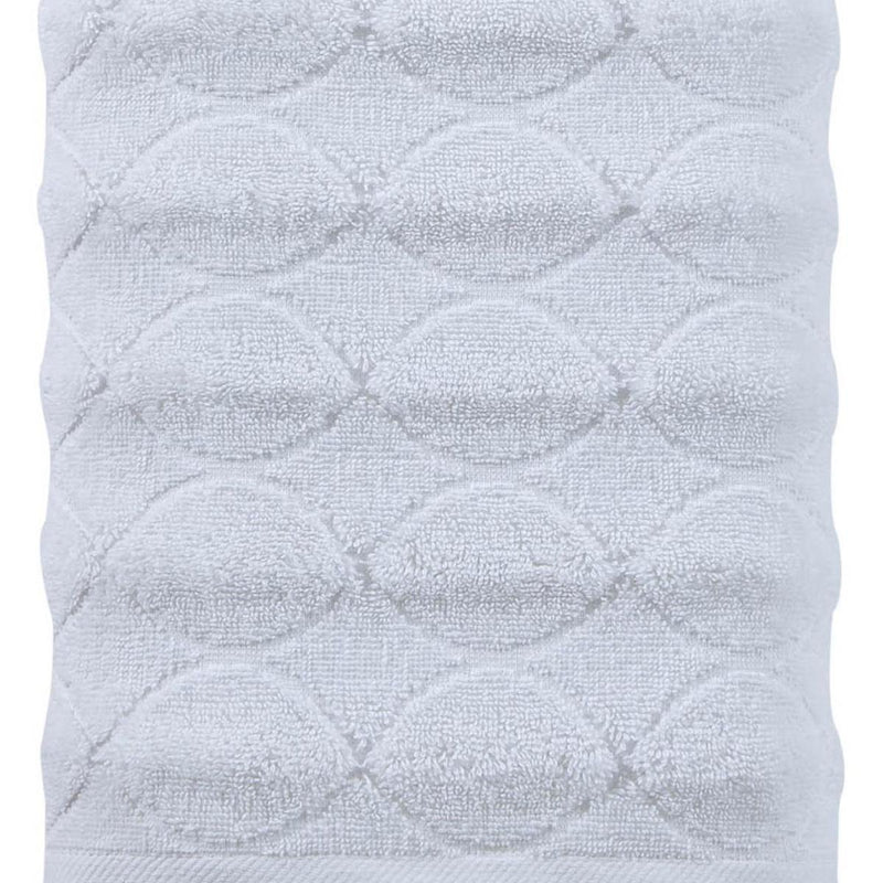 White bath towel close-up showing jacquard diamond grid with looped circular motifs