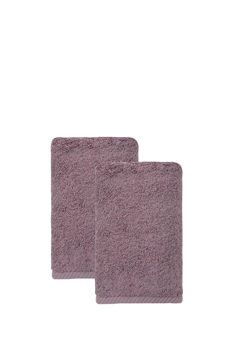 Set of two purple hand towels, folded stack with terry loop texture