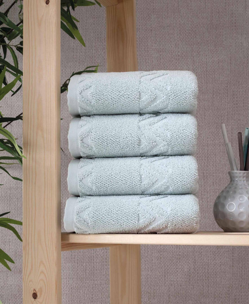 Aqua geometric Turkish cotton hand towels set, folded stack with chevron embroidery
