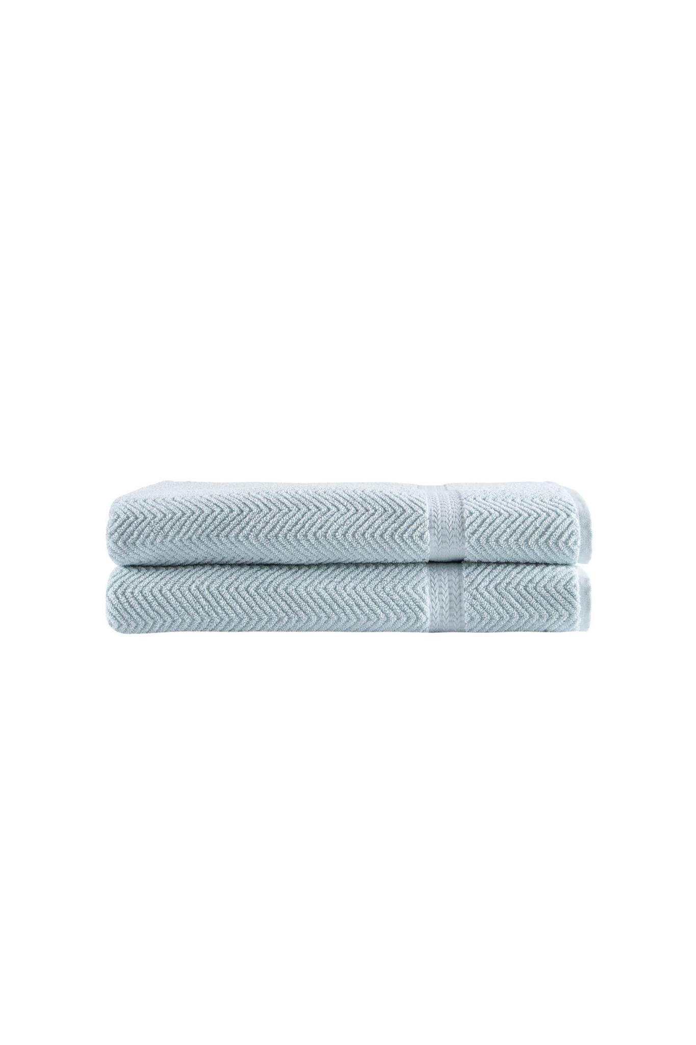 Two folded light blue chevron bath sheets with textured Turkish cotton weave