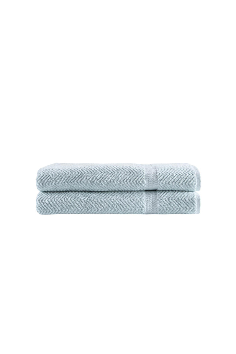 Two folded light blue chevron bath sheets with textured Turkish cotton weave