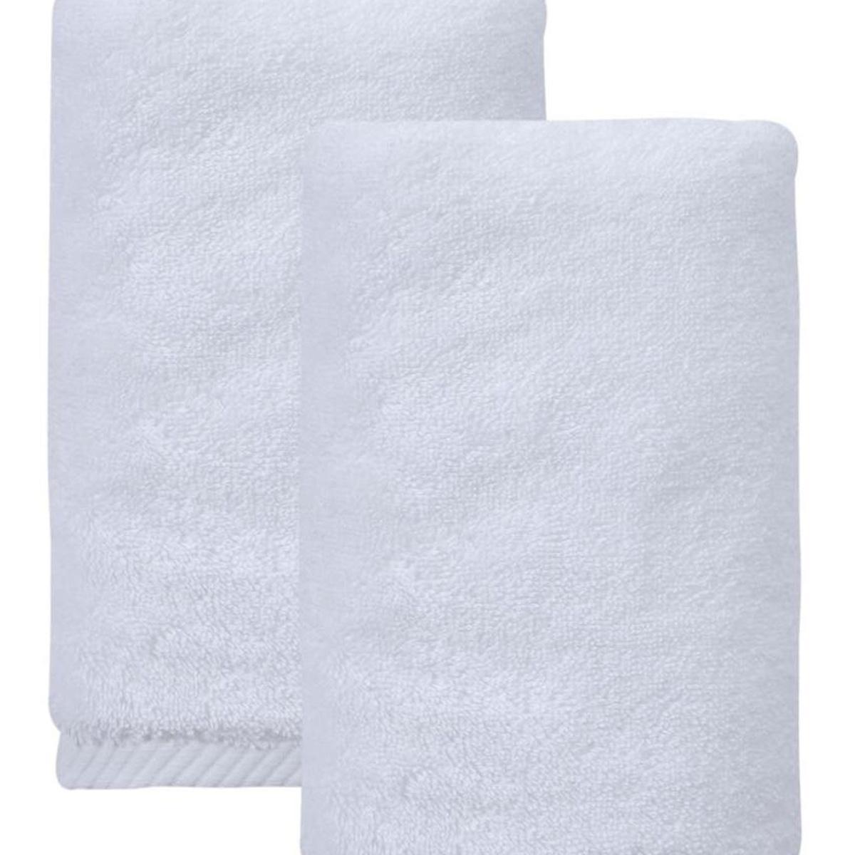Set of two white towels, close-up of folded Turkish cotton with textured weave