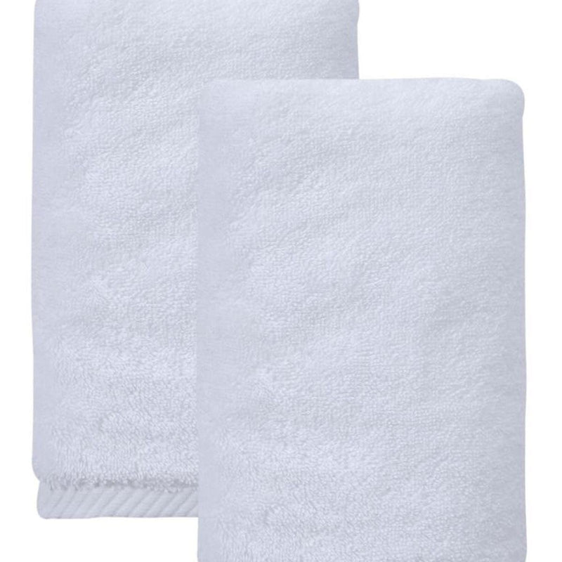 Set of two white towels, close-up of folded Turkish cotton with textured weave
