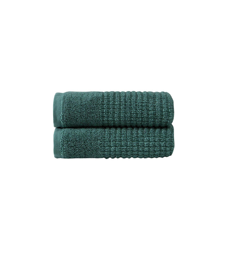 Green Turkish cotton hand towels, folded stack, woven textured fabric