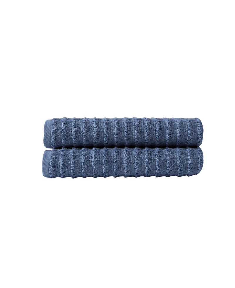 Navy geometric bath towels, rolled and stacked, textured Turkish cotton
