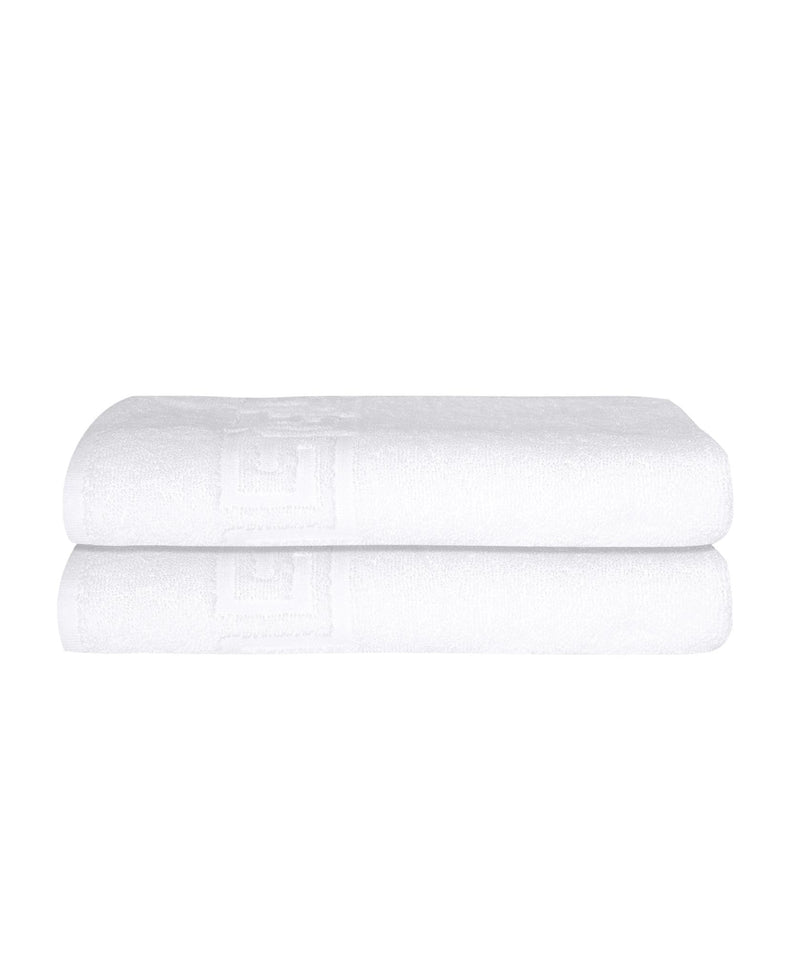 Set of two white Turkish cotton bath sheets folded into a tidy roll, Greek key trim