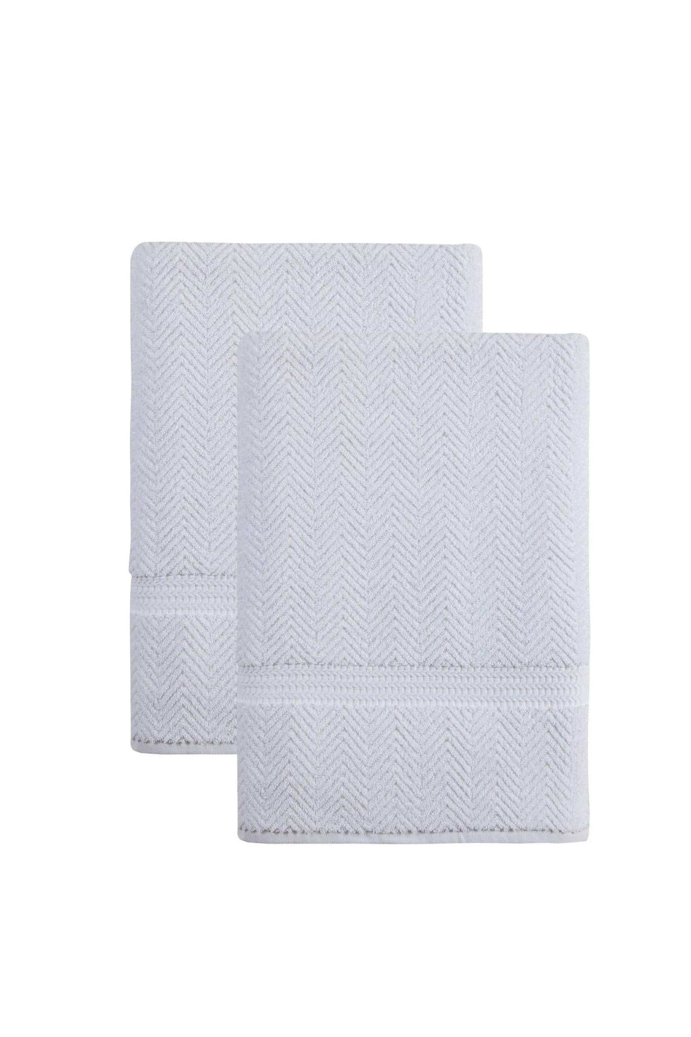 Set of two white Turkish cotton bath sheets with chevron weave, folded and stacked