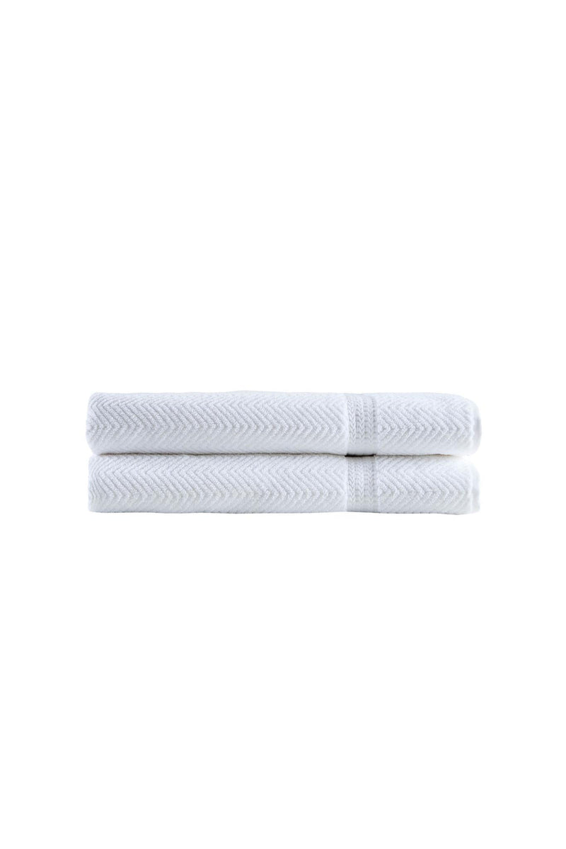 Two folded white chevron bath sheets with stitched hem, neatly stacked
