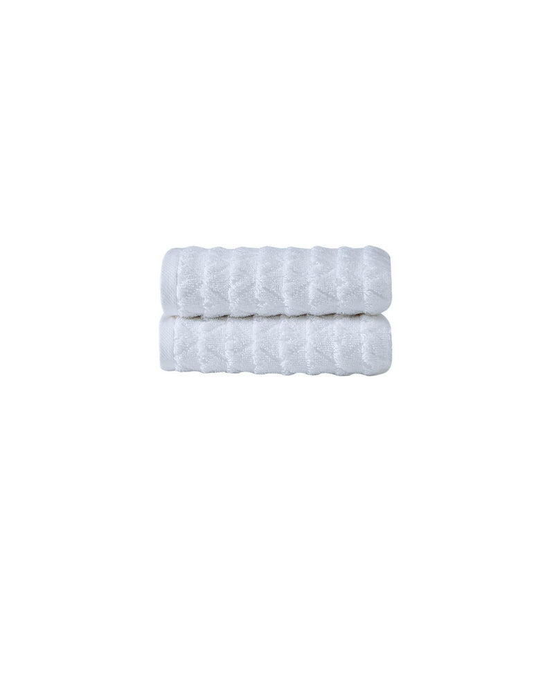 Set of two white Turkish hand towels with geometric woven pattern, neatly folded stack