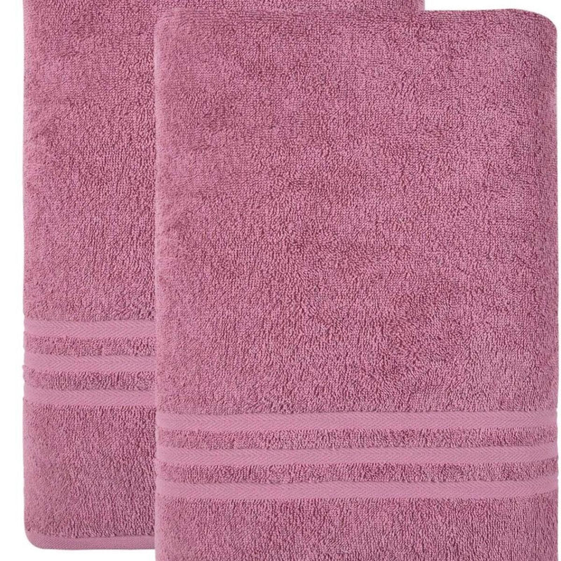 Pink bath sheet with terry texture and horizontal striped band near the bottom edge