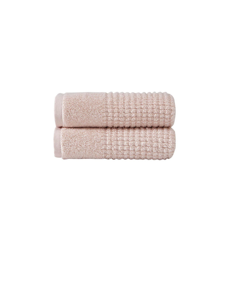 Set of two pink Turkish cotton hand towels, folded with textured waffle weave
