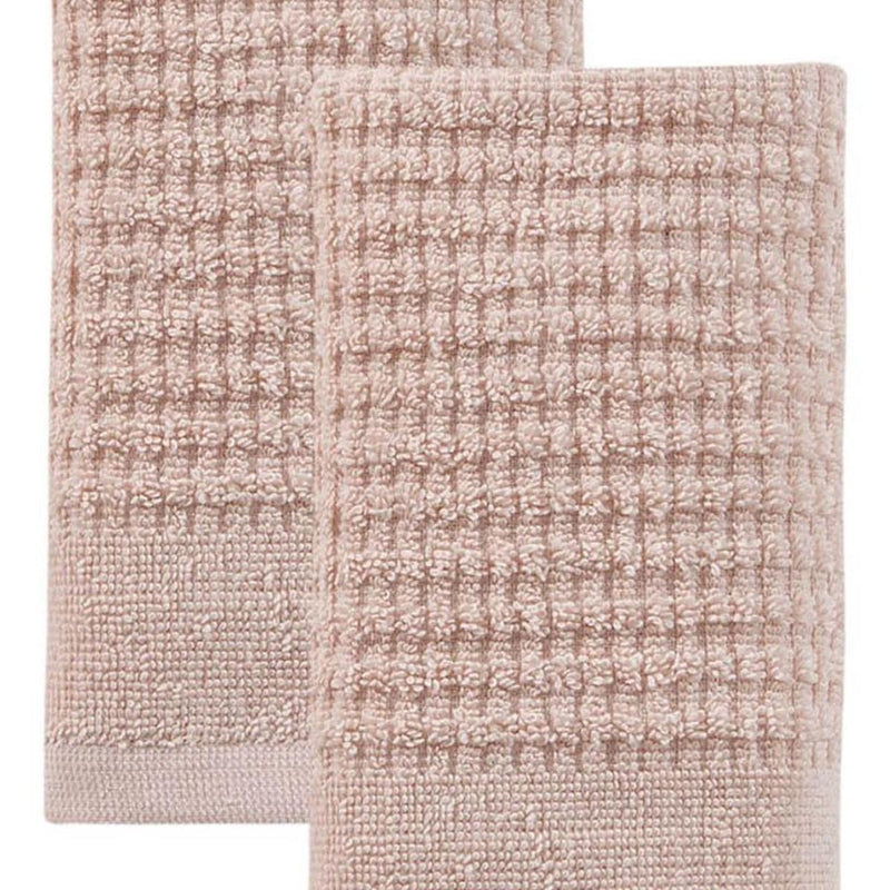 Pink Turkish cotton hand towel with textured waffle weave, close-up of folded fabric