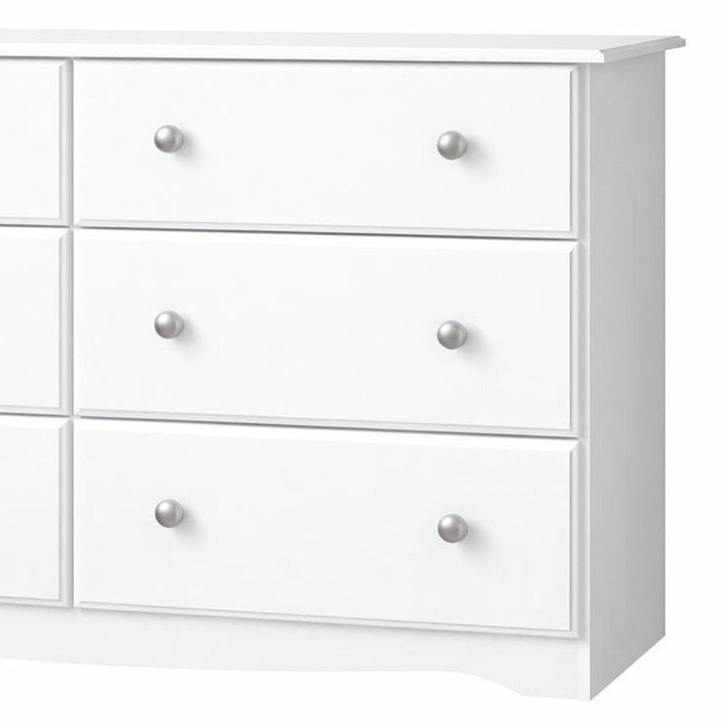 White dresser drawer unit with three stacked drawers and round silver knobs, side