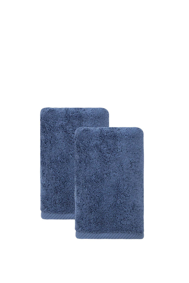 Set of two navy hand towels, one folded over the other, soft terry pile