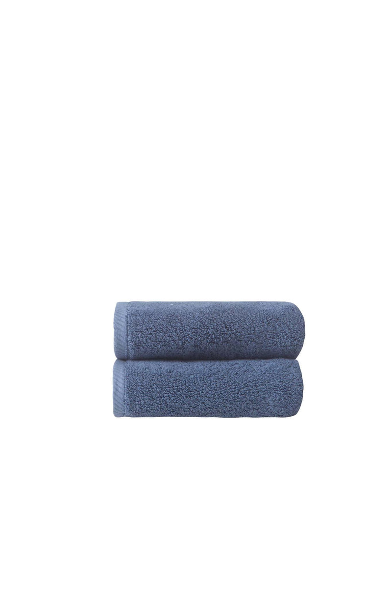 Set of two navy hand towels, neatly stacked, plush terry loops