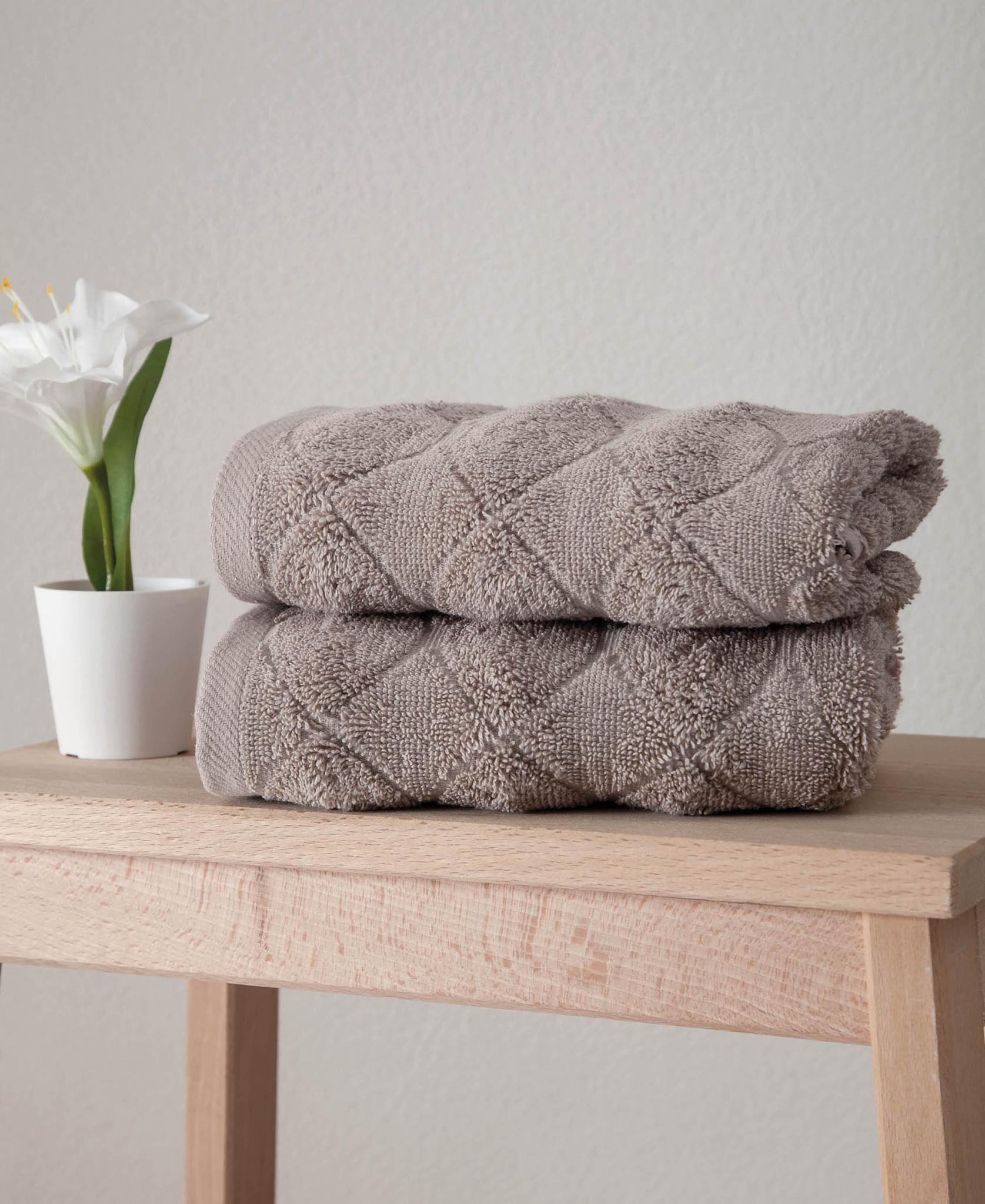 Set of two folded Turkish hand towels in taupe with geometric pattern