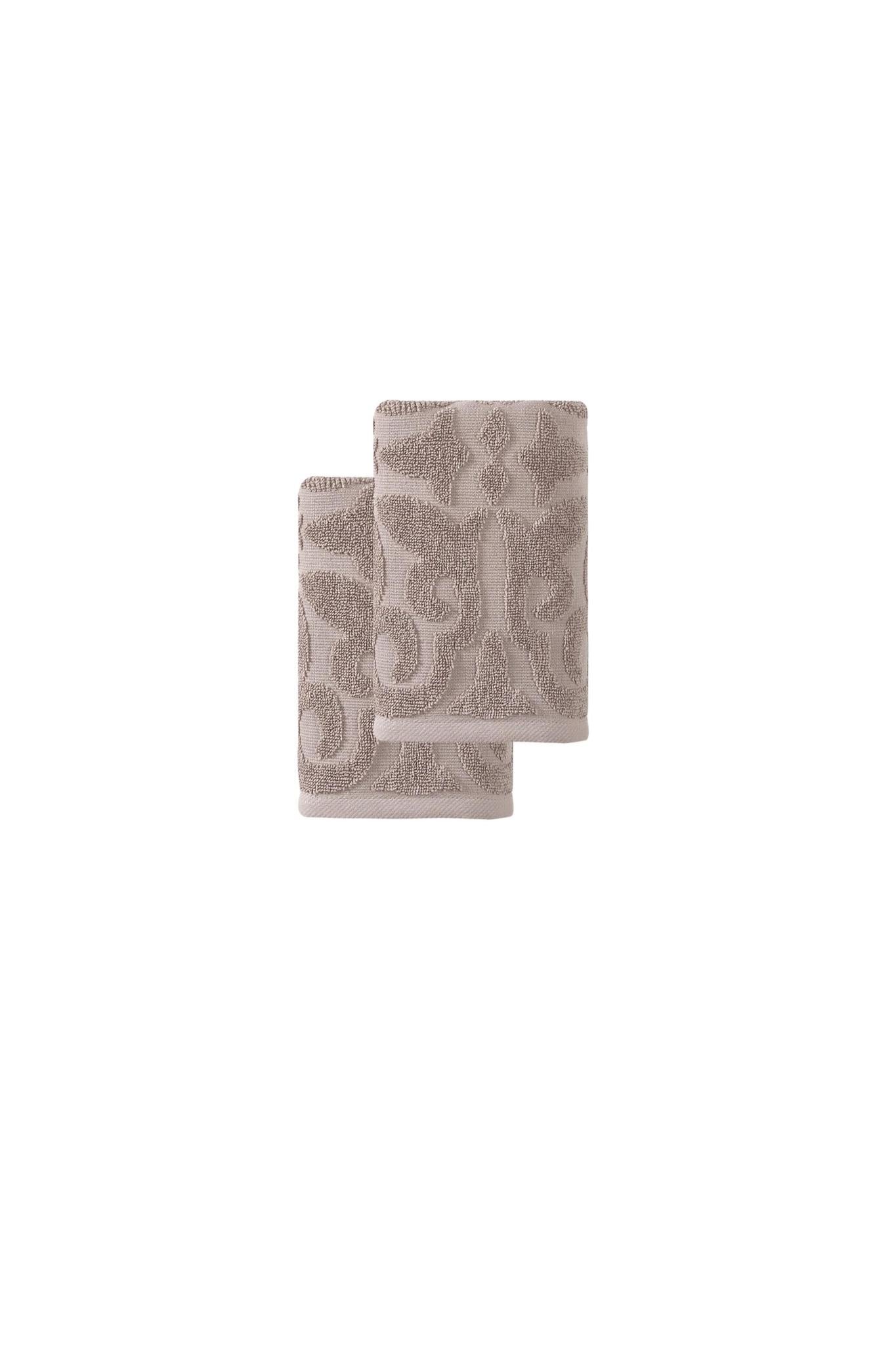 Pair of hand towels, folded terry cloth with repeating floral motifs in taupe
