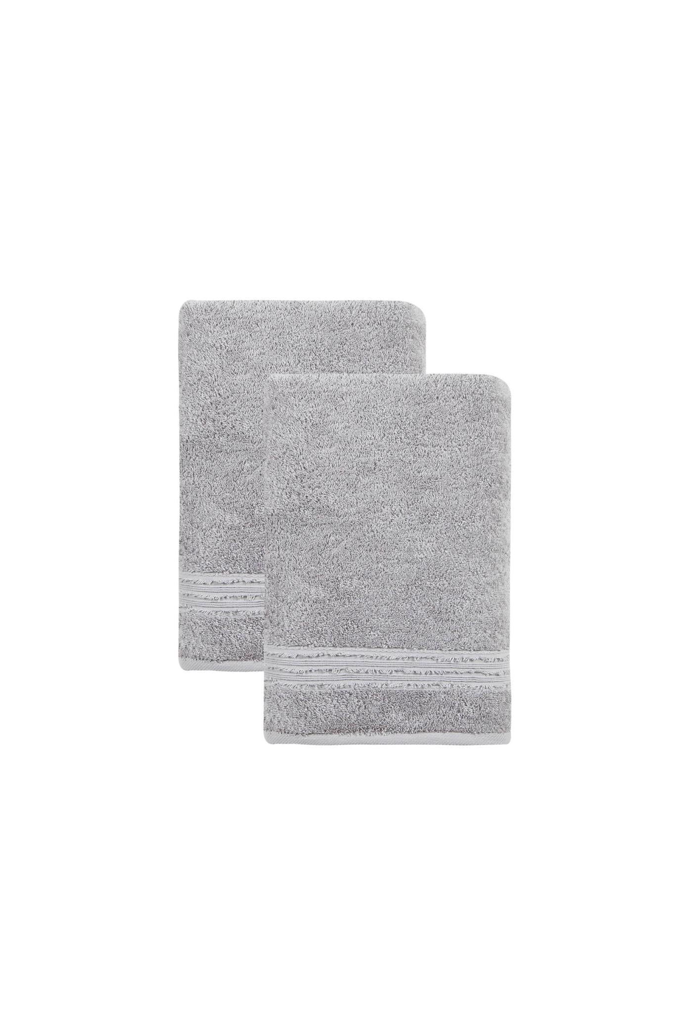 Two light gray bath towels stacked, textured terry with stitched border on folded edges