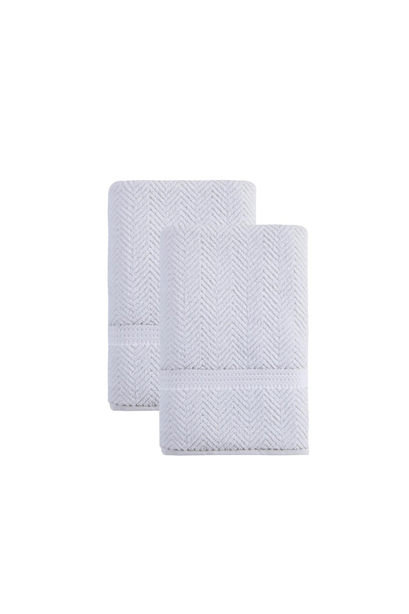 White chevron bath towels, neatly folded stack with stitched border